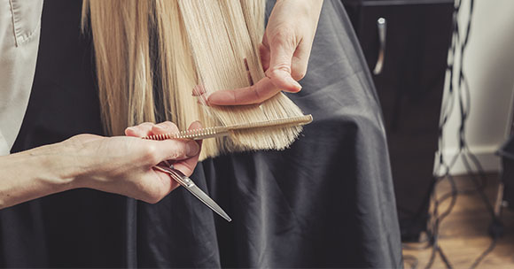 Friseur, der eine Frisur mit Wellen macht